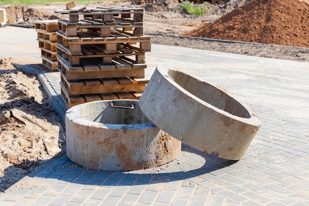 Reinforced concrete rings for the installation of underground wells at the construction site Reinforced concrete products for the device of underground communications Sewerage and plumbing