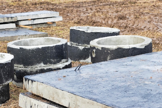 Reinforced concrete rings and slabs for wells on the construction site Preparation for the device of underground wells and communications Closeup