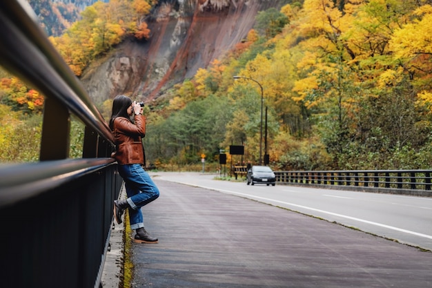 Reis Concept. Jonge reizende vrouw met camera foto te nemen in de herfst en de herfst