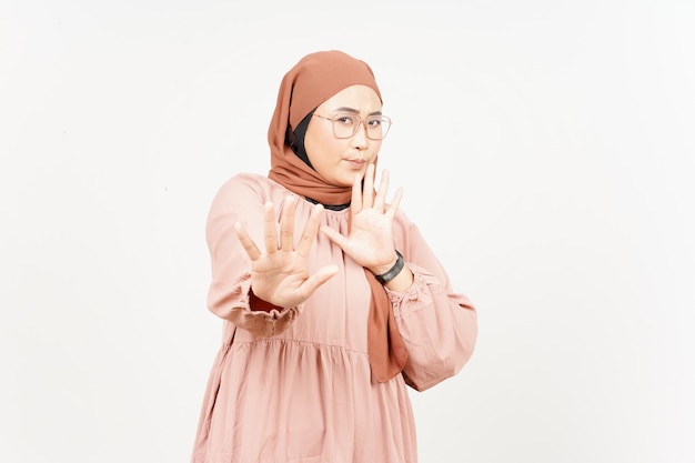 Rejection hand gesture of beautiful asian woman wearing hijab\
isolated on white background