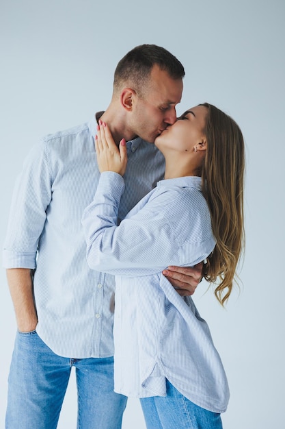 Relatie concept foto van een gelukkig stel in witte shirts en spijkerbroeken op een witte achtergrond Gelukkig jong stel