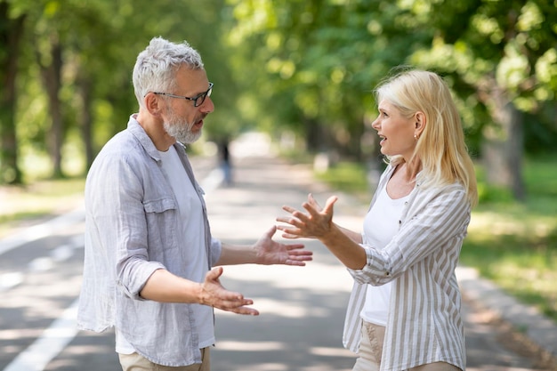 Relationship problems portrait of mature couple arguing outdoors
