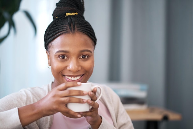 Relax coffee and smile with portrait of black woman for content weekend and lounge at home Happy break and lifestyle with girl in living room and mug of tea for peace beverage and comfortable