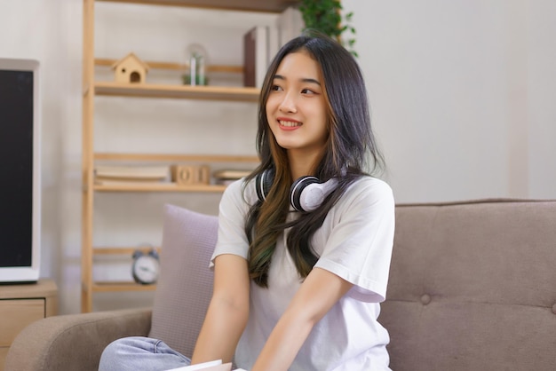 Relax at home concept LGBT lesbian female holding a book while sitting on the couch in living room