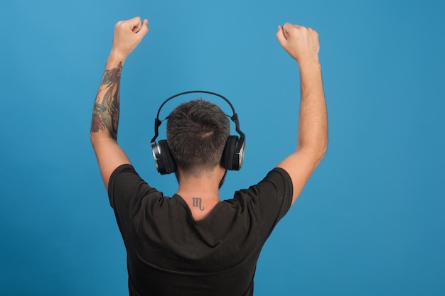 Relax and music concept Singer with beard enjoys music