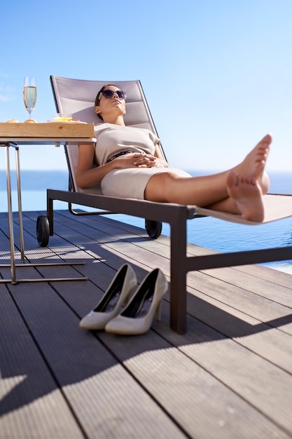 Photo relax pool and woman in chair with champagne brunch and business trip with hotel service travel hospitality and businesswoman with drink lunch and sunshine at luxury villa for summer holiday