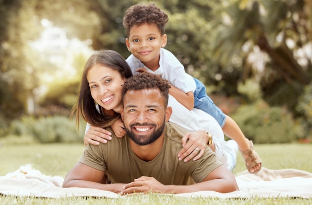 Relax smile and picnic with portrait of family in park for summer happy and nature Wellness spring and health with other and father embrace with child in grass field or countryside environment