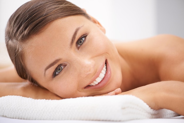 Relax smile and portrait of woman at spa with body massage for health wellness and self care Happy natural and female person with calm peaceful and serene skin therapy treatment at beauty salon