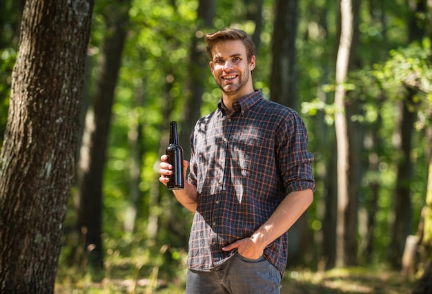 Relax on summer picnic weekend camping season begin he loves\
hiking tourism adventure concept drinking beer in camping do not\
leave garbage in forest ecology pollution man drink beer in\
forest