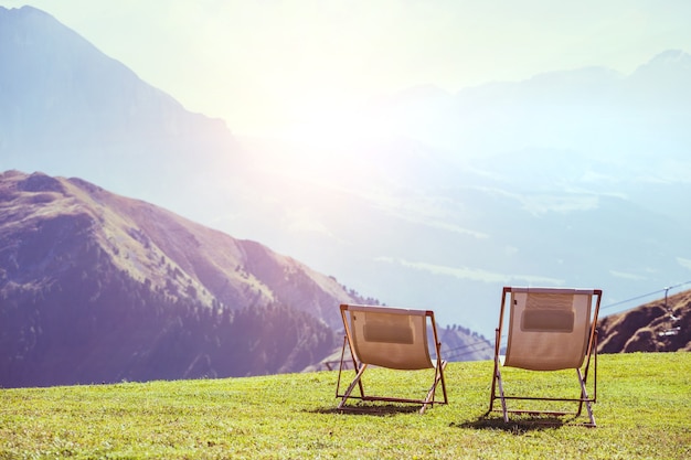 Relax - two chairs in the mountains. Seceda Dolomites,  Italy.