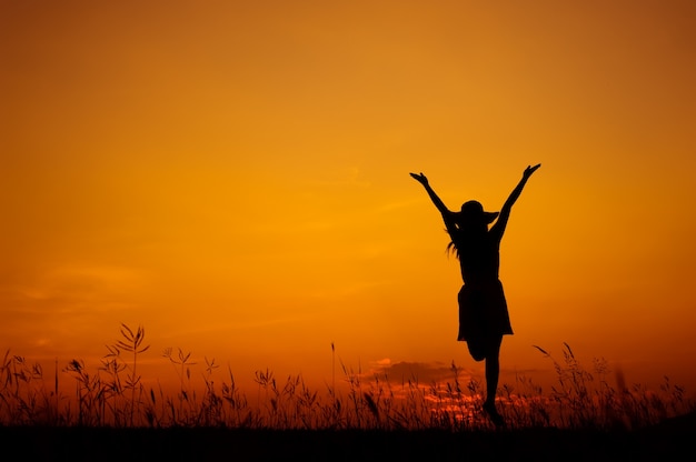 Relax woman and sunset silhouette