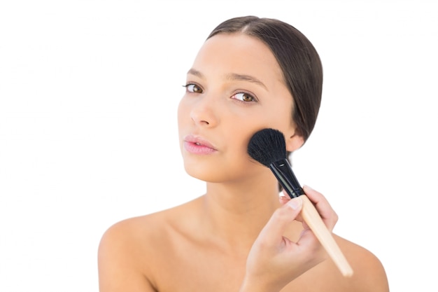 Relaxed bare model applying blusher