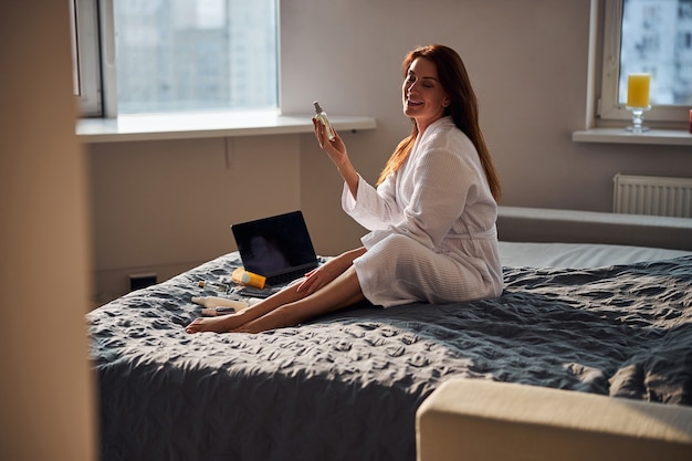 Relaxed brunette enjoying her beauty routine in the morning