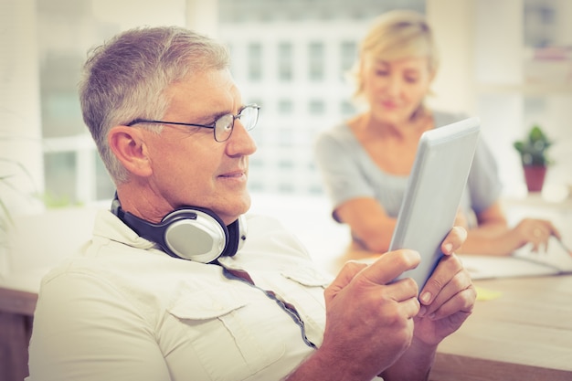 Photo relaxed businessman looking at his tablet