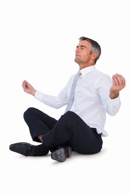 Relaxed businessman in lotus pose