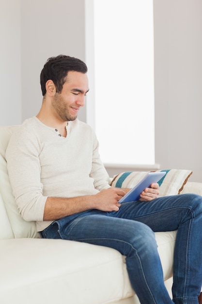 Relaxed casual man using his tablet