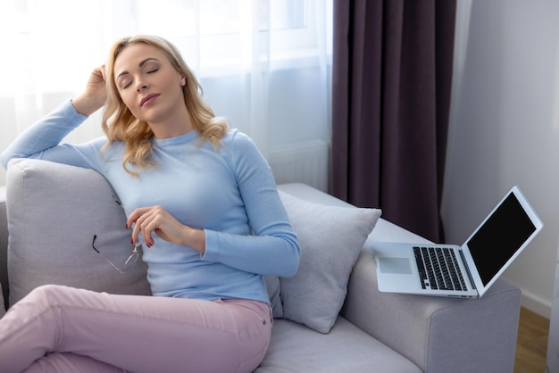 relaxed female freelancer taking a break from her laptop