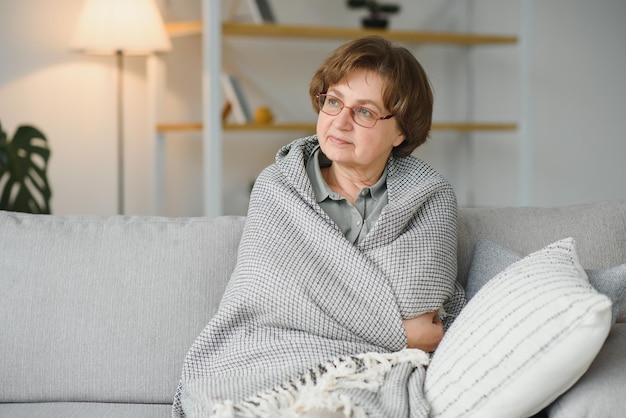 Relaxed grandmother sitting on the couch at home