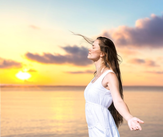 Relaxed happy young woman on beach