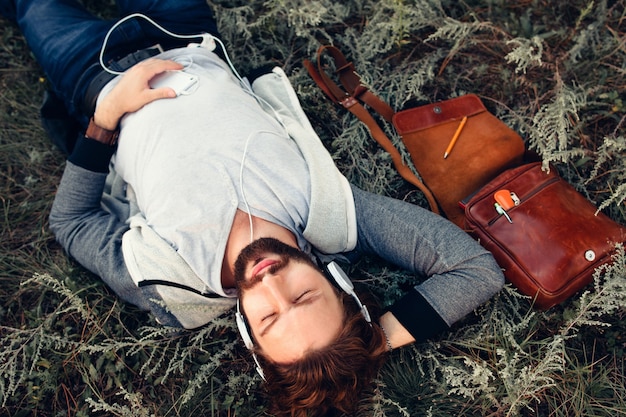 Relaxed man listening to music at nature