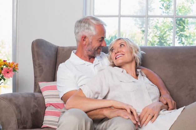 Relaxed mature couple sitting on couch