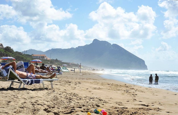 Relaxed people on the Sabaudia beach for the summer holidays The Circeo Mountain on the background Sabaudia Lazio Italy