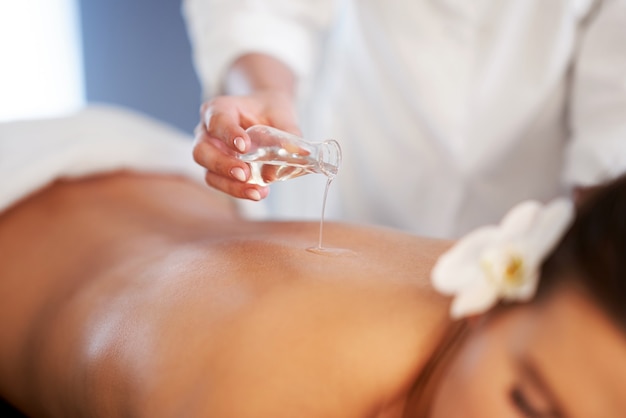 Relaxed smiling woman receiving a back massage in a spa