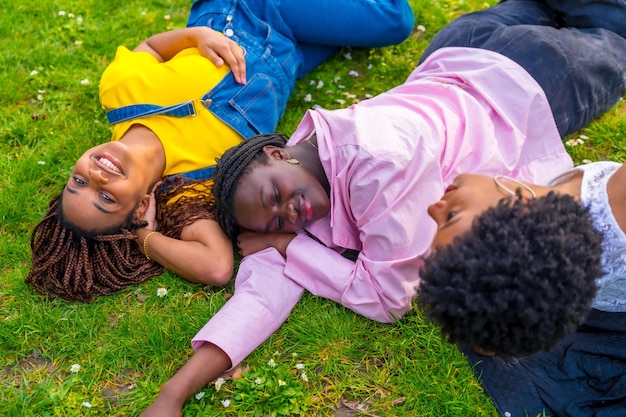 Relaxed students lying on the grass of the campus