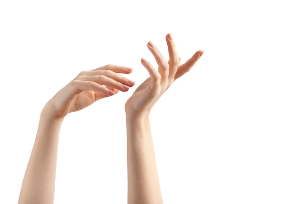 Photo relaxed two female hands with beige nails manicure on white