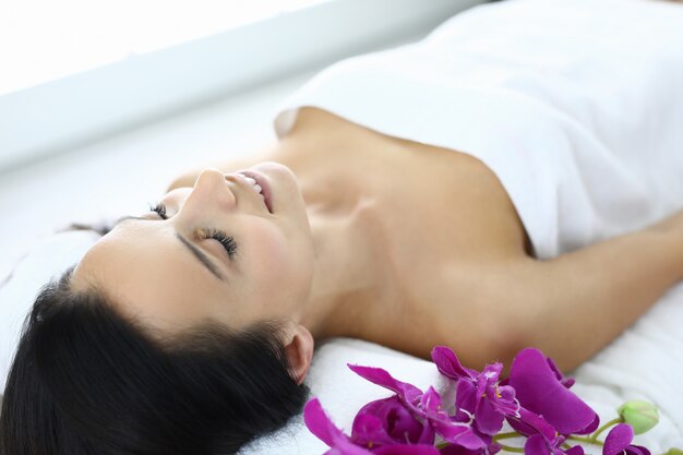 Relaxed woman after oil massage at spa.