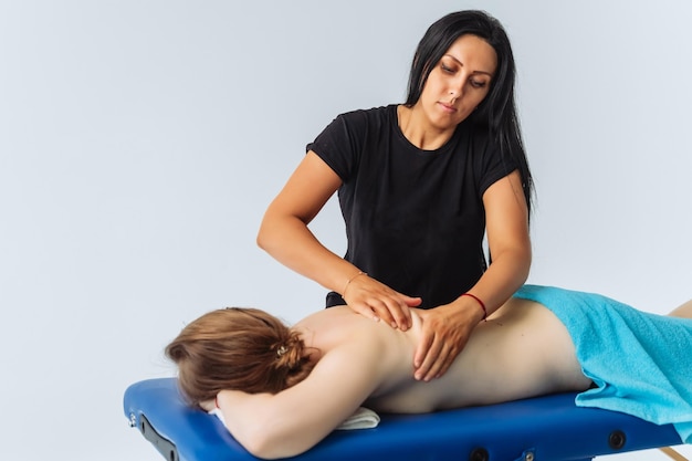 Relaxed woman getting back massage in luxury spa