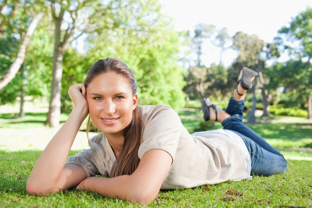 Relaxed woman lying in the park