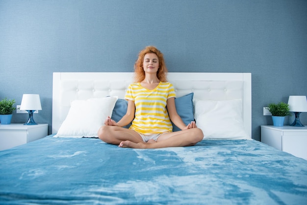 Relaxed woman meditating on bed retreat yoga retreat and\
meditation meditative retreat
