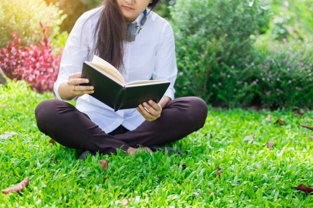 Relaxed woman reading a book in the garden