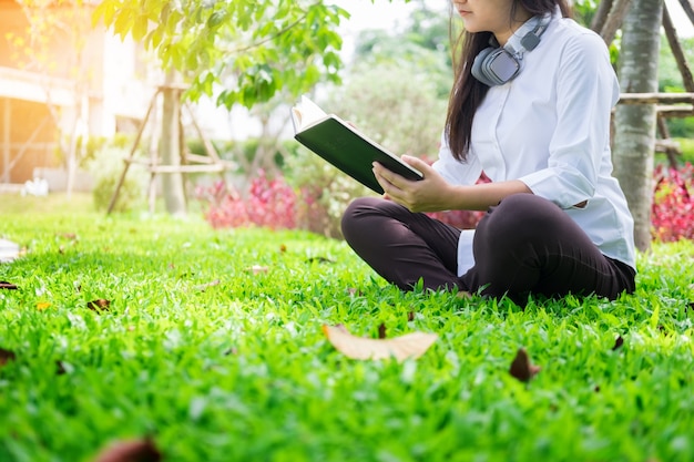 Relaxed woman reading a book in the garden