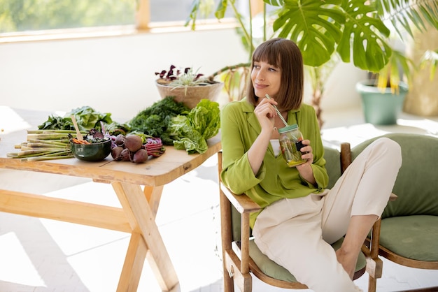 Photo relaxed woman with healthy food in the room with plants