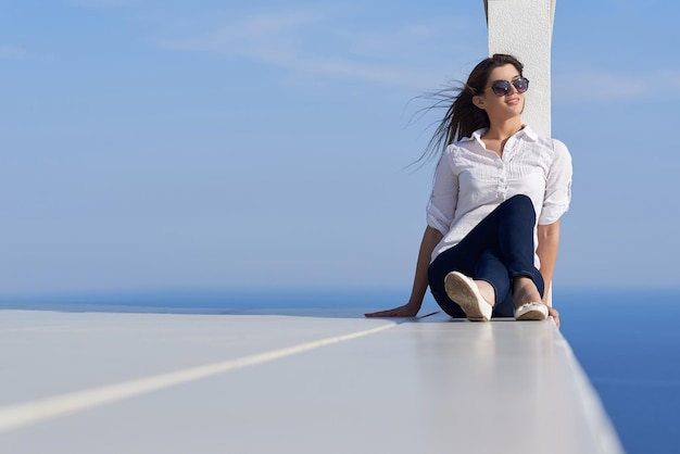 relaxed young beautiful woman in front of luxury modern home villa  on balcony on sunny day