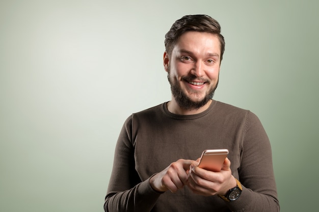 Relaxed young casual man reading text message