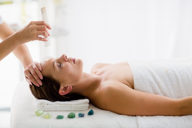 Relaxed young woman receiving massage treatment