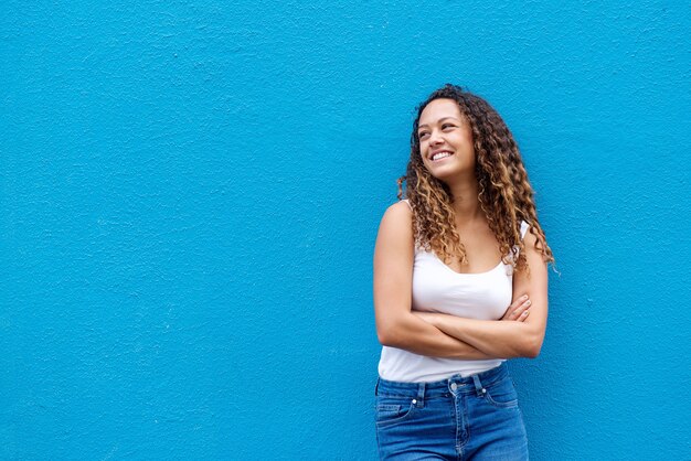 Relaxed young woman smiling with arms crossed