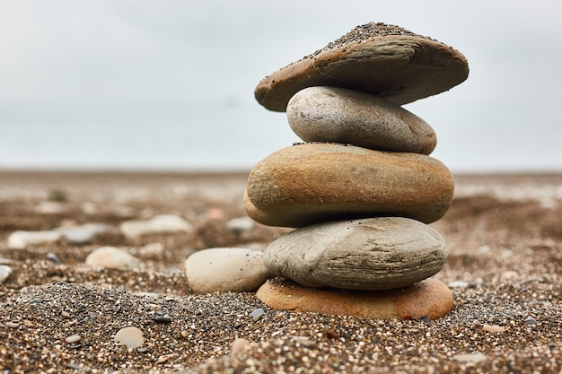 Photo relaxing on the beach, stack of stones