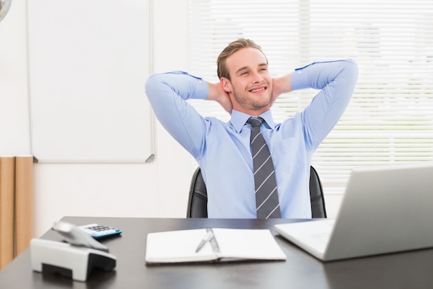 Relaxing businessman at his desk 