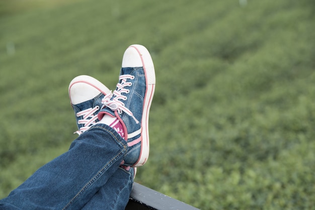 Relaxing on green natural with legs up, close up.