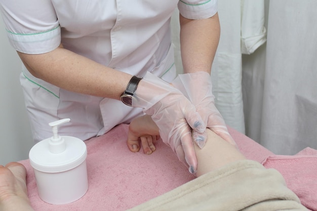 Relaxing massage on the foot in spa salon indoors