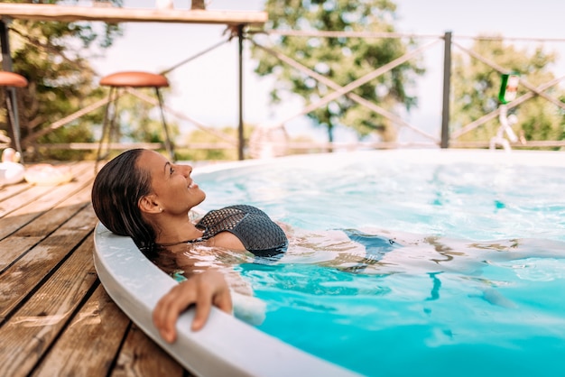 Relaxing in outdoors swimming pool.