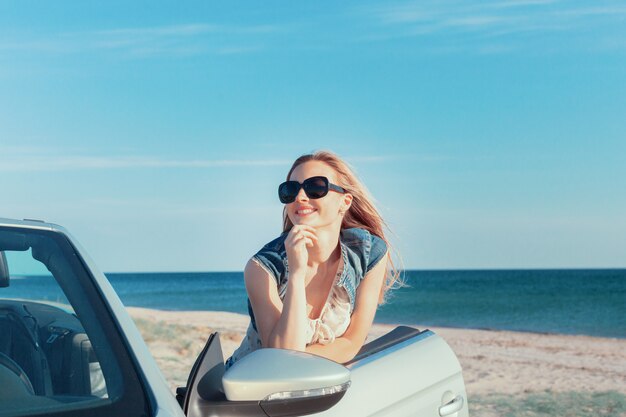 車のビーチでリラックスした女性