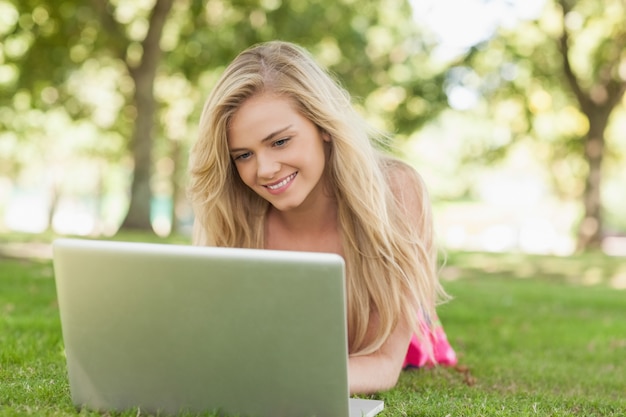 Relaxing young woman using her notebook 