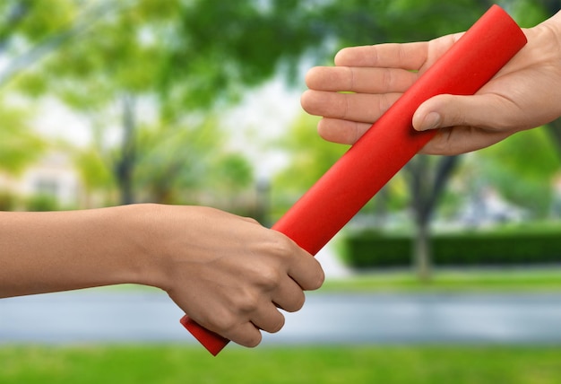 Relay baton being passed, close-up view