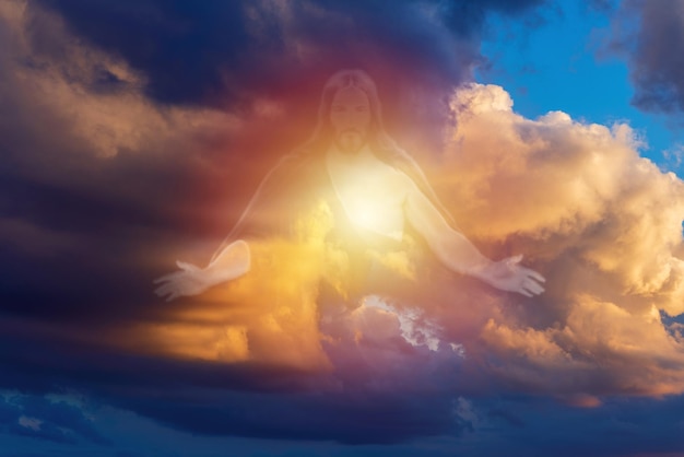 religionreligious conceptsilhouette of god on sky clouds backgroundjesus christ in dramatic cloudssunlight from heavenblurred soft focus