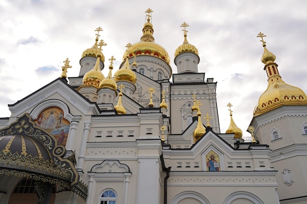 Religious buildings Pochayiv Ukraine 2021 may orthodox church with golden domes Trinity cathedral and bell tower in Pochaev Lavra